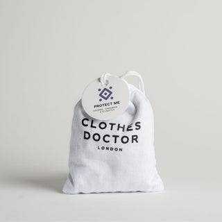 A white cotton sachet labeled 'Protect Me - Clothes Doctor London' containing natural scent bags for wardrobe use.