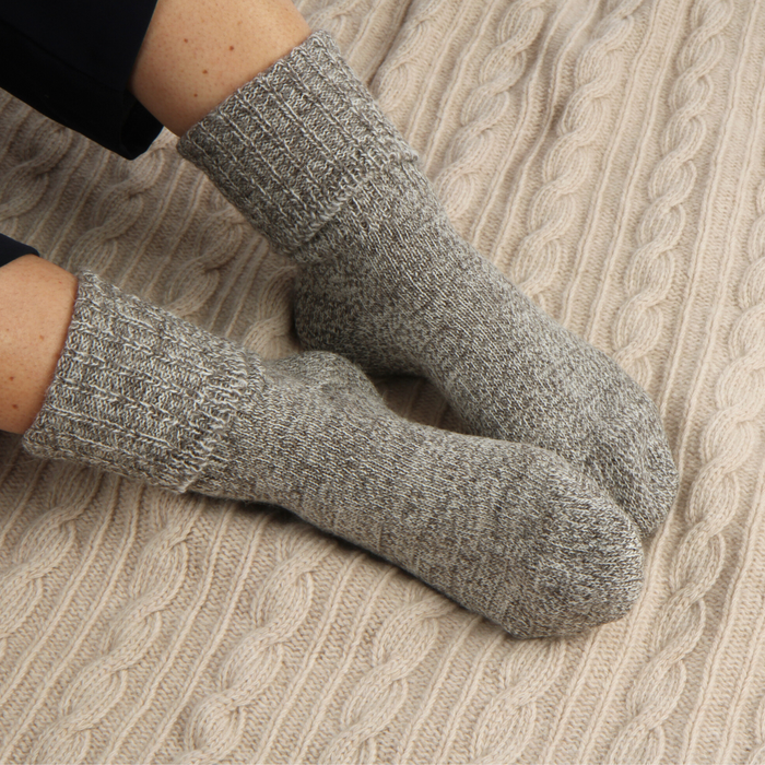 Gray socks worn on a textured surface