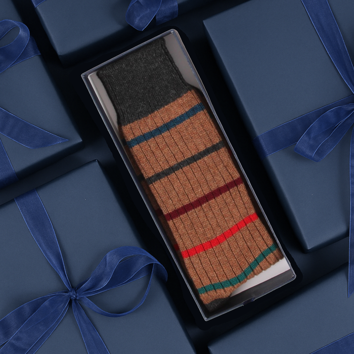 Striped sock in a box with blue gift boxes in the background