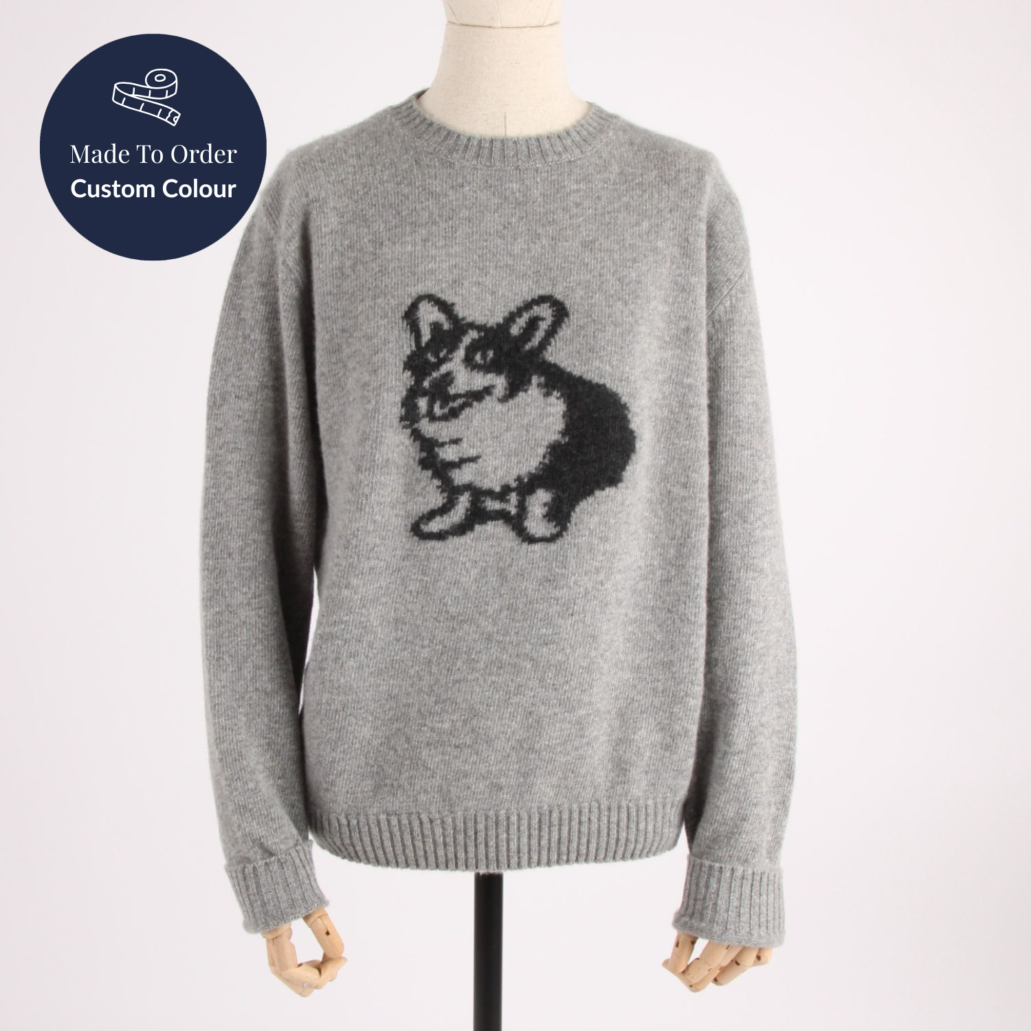Gray sweater with a dog design on a mannequin against a white background