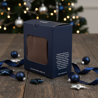 Navy box packaging with a brown sock inside on a white background