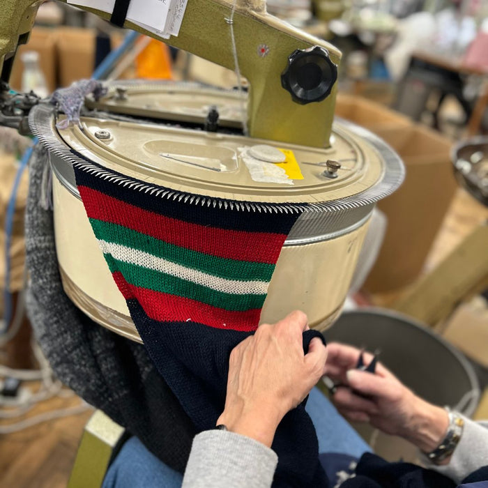 Corgi staff member working on linking the scarf in the factory.