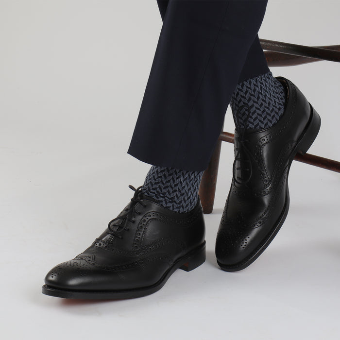 A pair of men's formal socks with a geometric pattern in gray and blue colors.