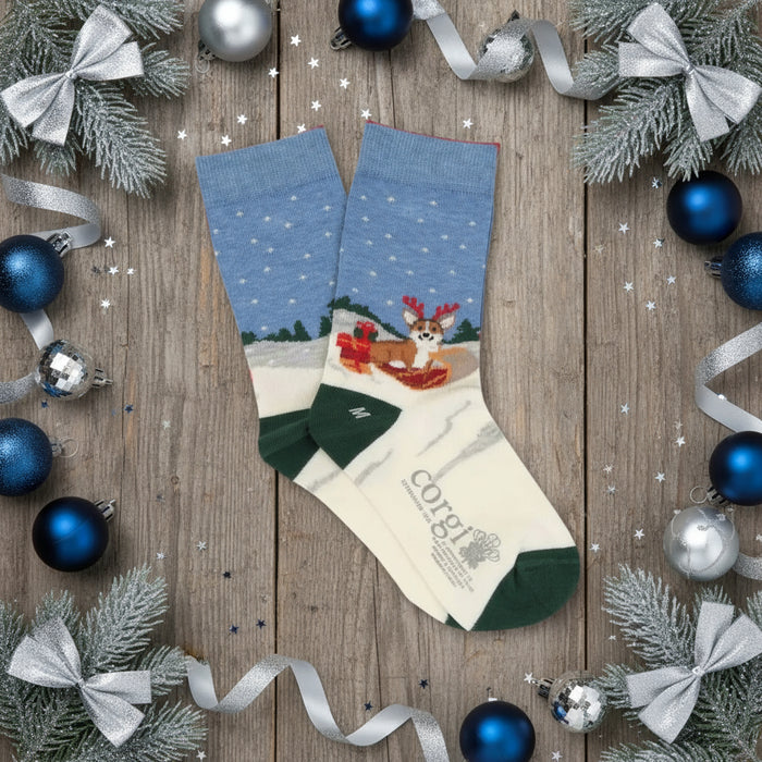 A pair of kids' Christmas themed cotton socks featuring a corgi dog design with holiday decorations and Corgi brand label.