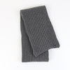 Grey knitted scarf on a white background