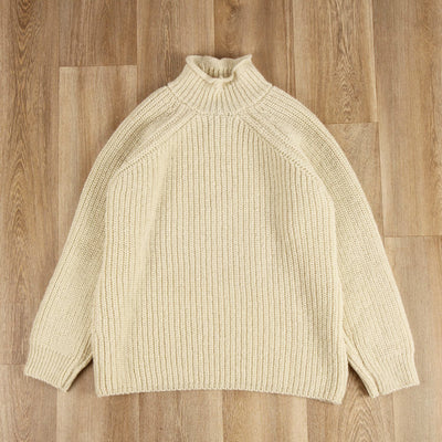roll neck pullover on a wooden floor