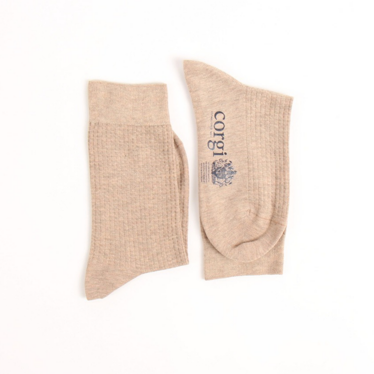 A pair of textured ankle socks in a light beige or oatmeal color, with one sock showing the side and the other showing the top and foot. The top features the brand name 'corgi' printed in black next to a small crest logo.