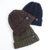 Three knit hats in brown, navy, and green on a white background