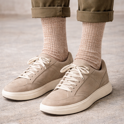 A pair of brown wool and cotton socks with a ribbed design. 