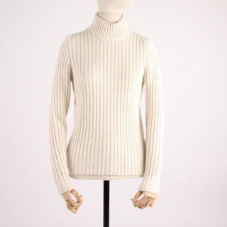 white rib turtleneck sweater on a mannequin against a white background