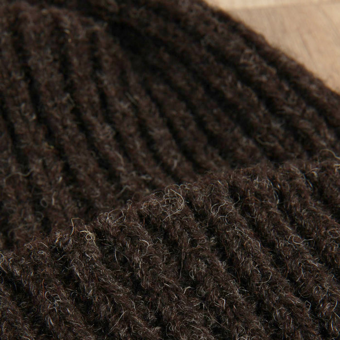 Close-up of a textured brown fabric surface