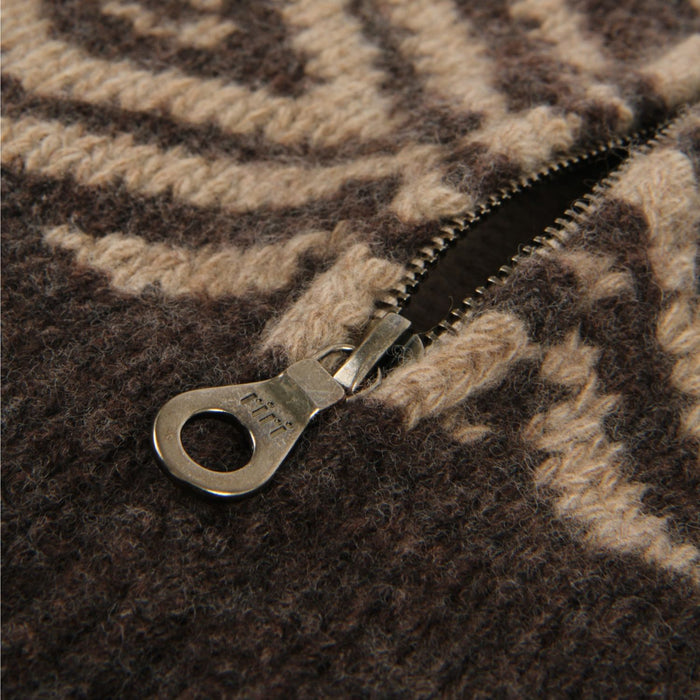Close-up of a zipper on a textured brown fabric surface

