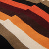 Close-up of fabric with multicolored stripes in brown, orange, and beige.