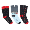 three pairs of men's socks with a Christmas-themed design, including a cityscape. 