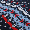 Close-up of a patterned fabric with red, blue, and white colors.