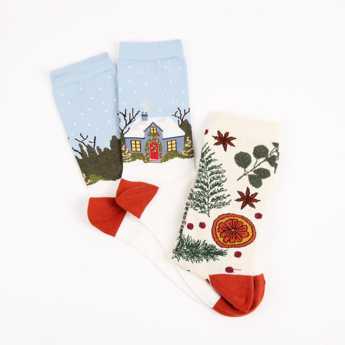 Two pairs of socks with winter-themed designs on a white background
