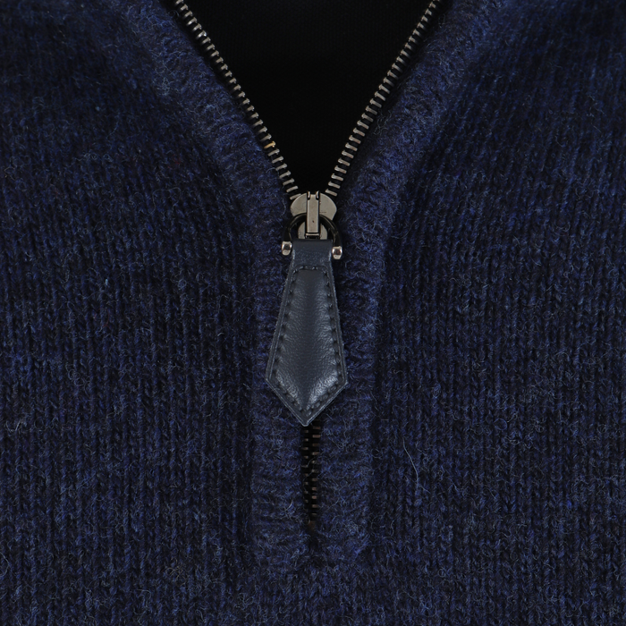 Close-up of a navy blue zip-up garment with a zipper detail.