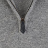 Close-up of a zipper on a gray fabric background