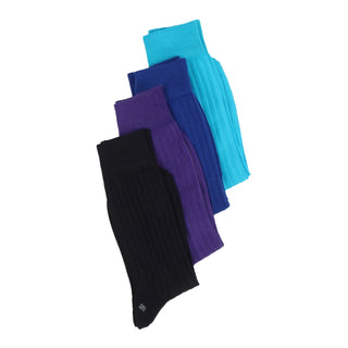Four pairs of socks in tonal blue shades photographed on a white background