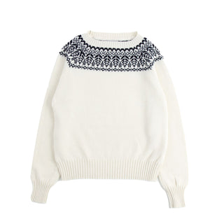 White sweater with navy patterned collar on a white background