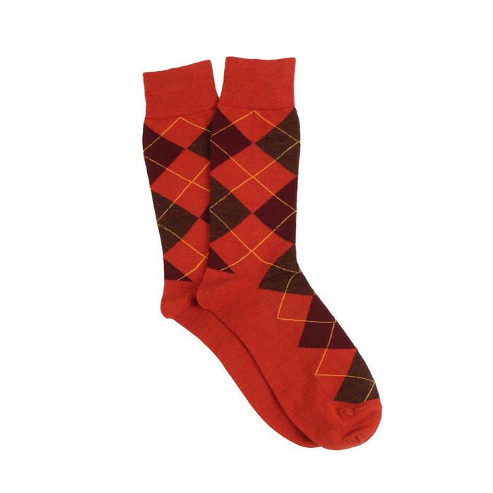 Orange argyle patterned socks on a white background
