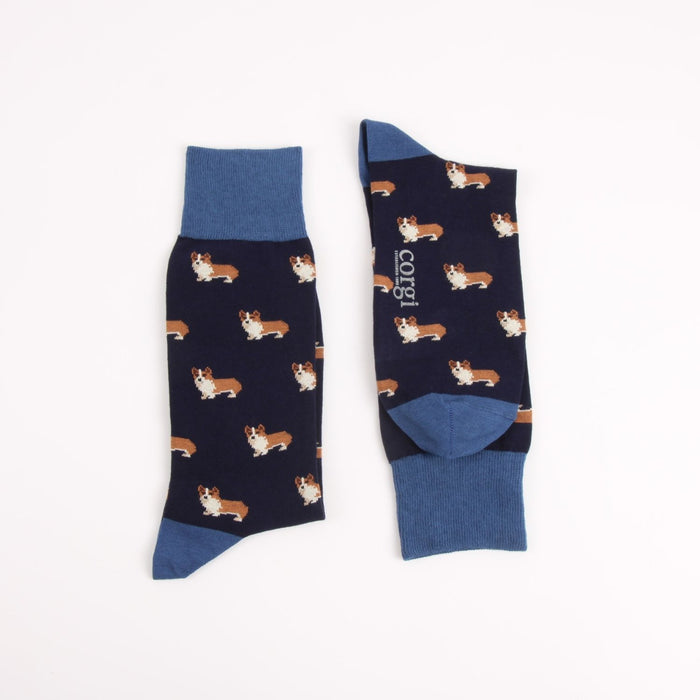 Pair of navy socks with an all over corgi dog logo and brighter blue top, heel and toe photographed on a white background
