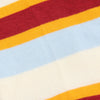 Close-up of multicolored striped fabric with red, orange, yellow, blue, and white stripes.