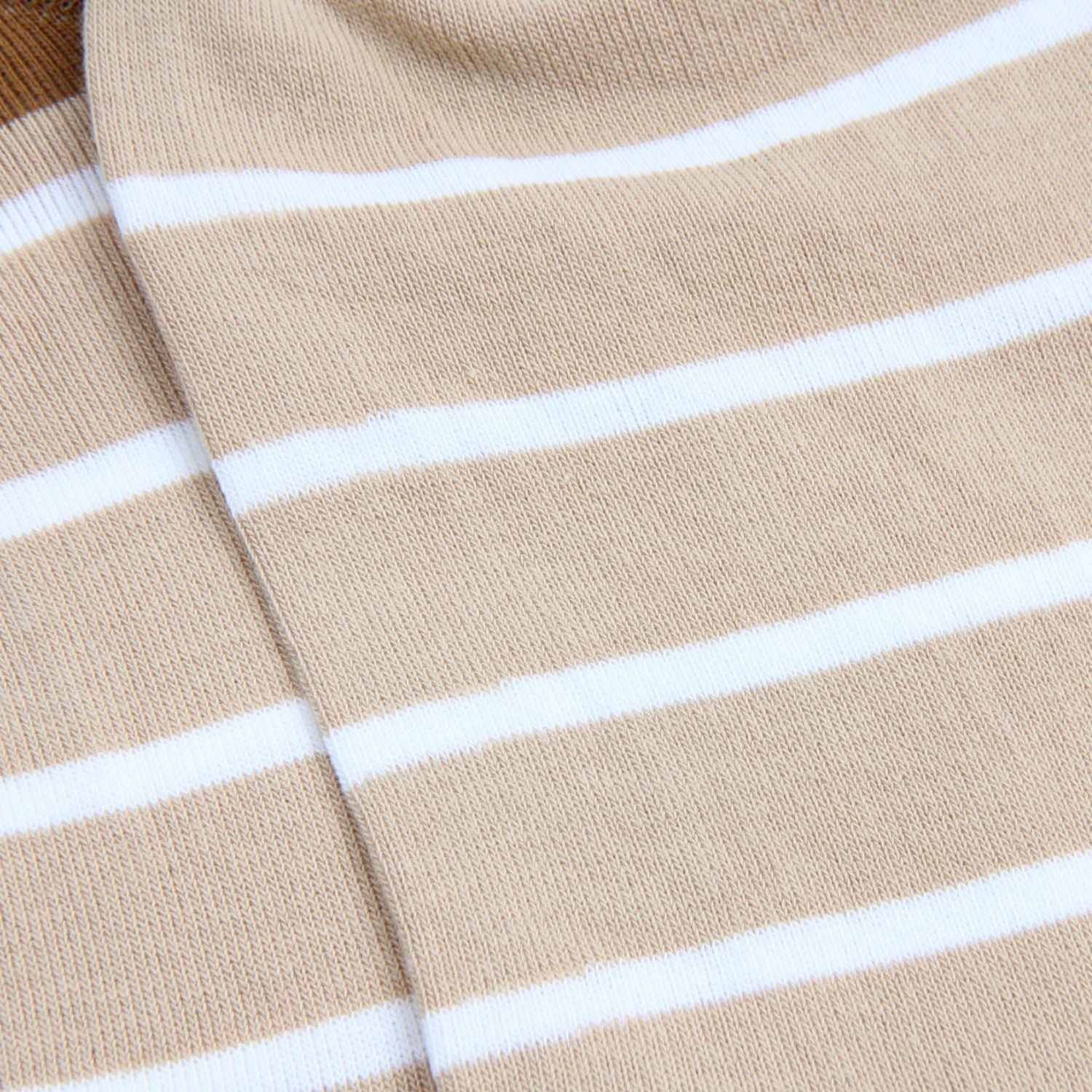 Close-up of beige fabric with white stripes