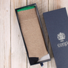 Beige sock with green tipping in an open box on a wooden surface, with 'corgi' branding visible.