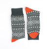 Pair of green and orange patterned socks on a white background