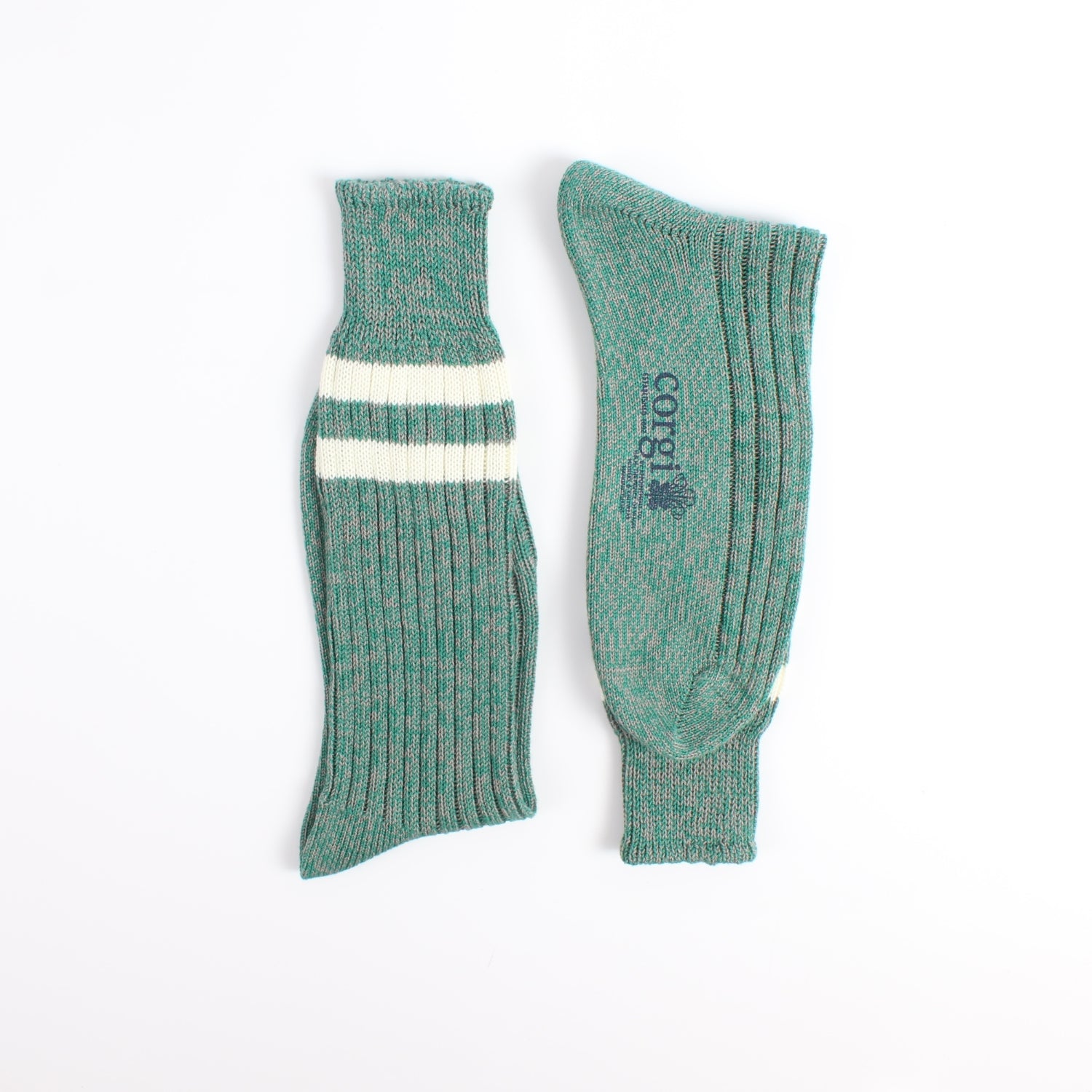 Pair of green socks with a white stripe photographed on a white background