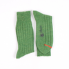Green socks with a visible brand logo on a white background