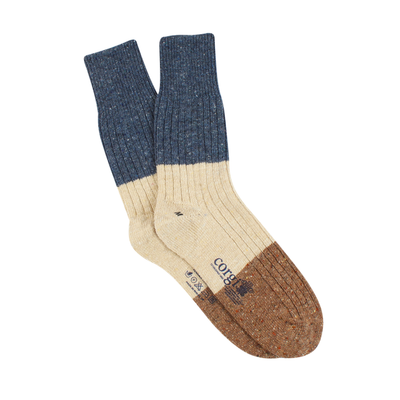 A pair of men's color block donegal wool socks with a tweed pattern at the cuff and solid color sections in blue and beige.