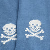Blue fabric with white knitted skull and crossbones pattern