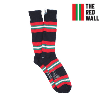 A pair of striped boot socks in red, white, and blue colors, with the text 'THE RED WALL' on the cuff.