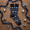 Navy socks with white snowflake and geometric pattern on a white background