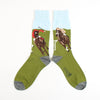 A pair of patterned cotton socks featuring a horse racing scene with green, brown, white, and gray colors.