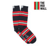 A pair of striped cotton socks with red and green horizontal stripes on a navy background, with the text 'THE RED WALL' on the cuff.