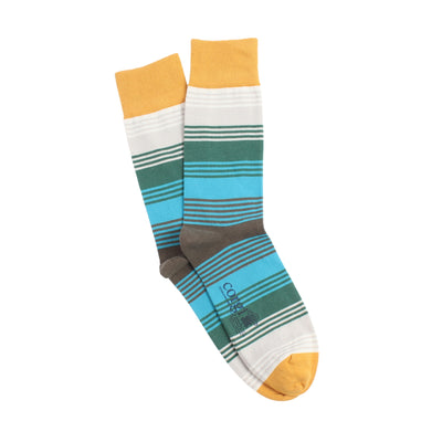 Colorful striped socks with a gold top and toe, green, blue and neutral stripes brand logo on a white background