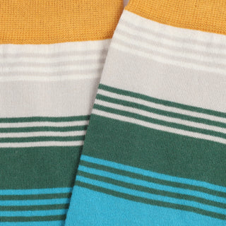 Close-up of striped socks with gold, white, green, and blue colours.