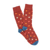 Rusty red socks with multicolored polka dots on a white background