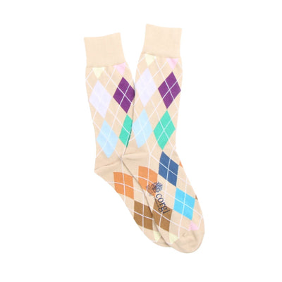 Pair of argyle pattern socks in neutral shades on a white background