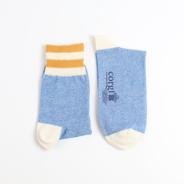 left and right view of a mid blue sock with a white and yellow striped top section