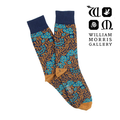 Patterned socks with blue and brown design on a white background, featuring the William Morris Gallery logo.