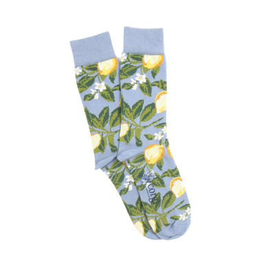Light blue socks with lemon and leaf pattern on a white background