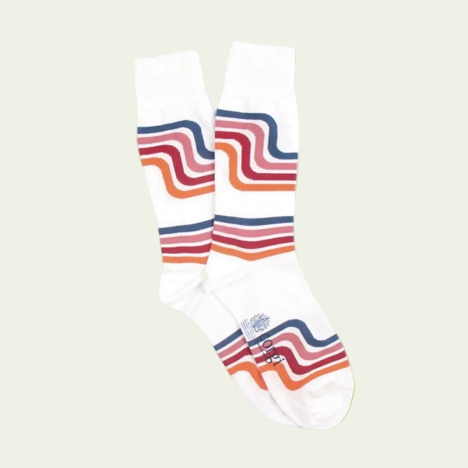White sock with colorful wavy stripes on a bluebackground