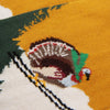 Close-up of a knitted design featuring a fturkey skiing with a yellow background.