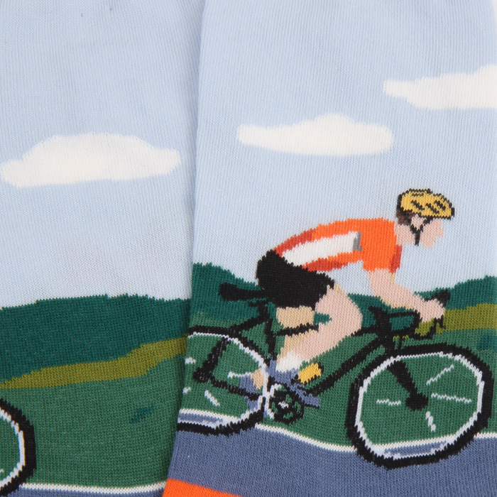 Socks with a cyclist design on a light blue background