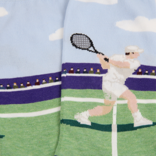 Tennis-themed sock with a player on a court design against a blue sky background