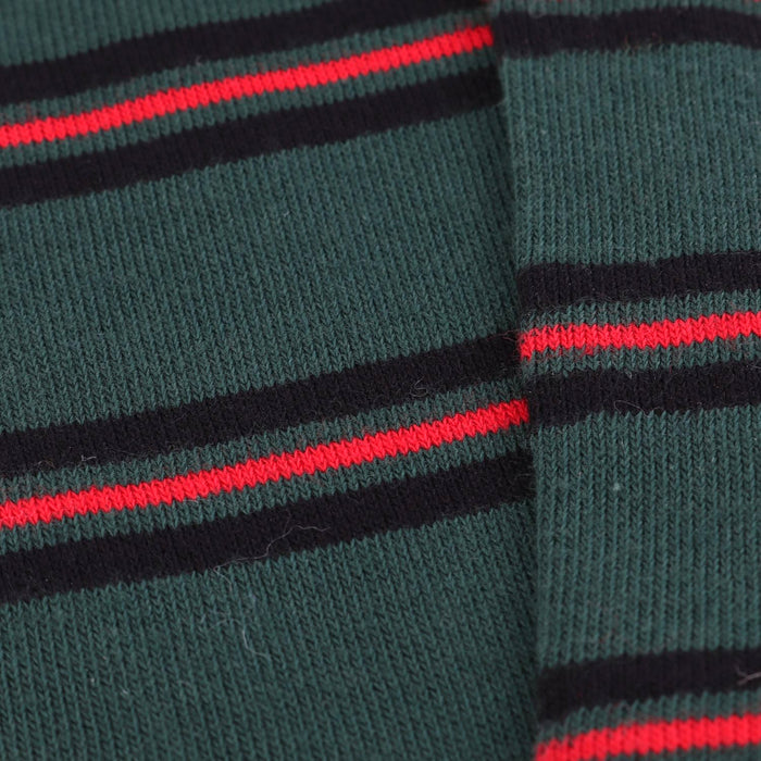 Close-up of green socks with red and black stripes